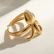 Experience beach life all year round with our Octopus Open Ring. This charming accessory is perfect for those who love forever summer vibes. Its cute design will add a touch of whimsy to any outfit. Get your hands on this must-have piece now.

Metal: 18K Gold over Stainless Steel&nbsp;

Size: Adjustable fits size 7/8