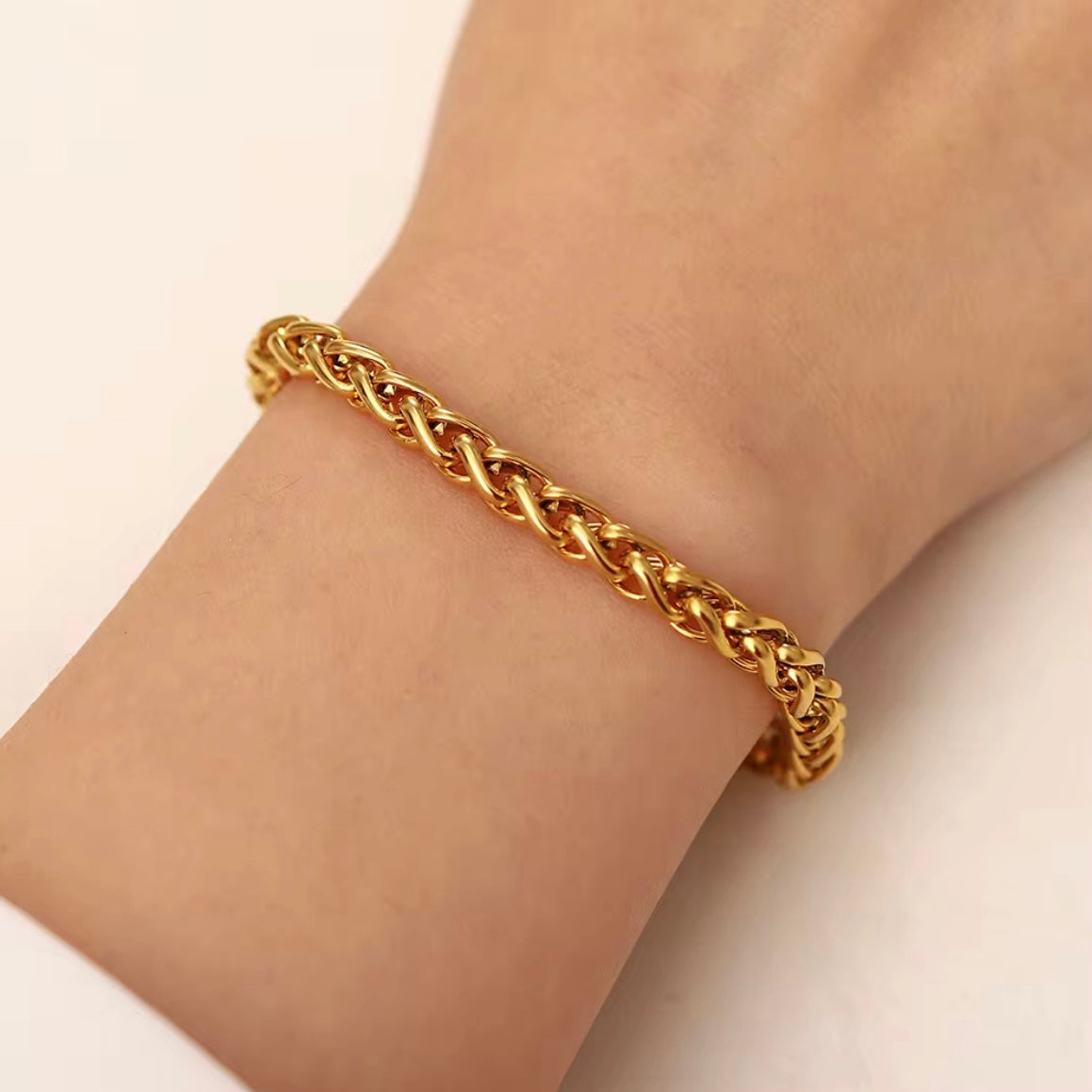 The Paola Bracelet boasts a timeless woven design and is crafted to resist tarnishing, ensuring its elegance and quality lasts for years to come. Exude sophistication and effortless style with this beautiful accessory.



316L Stainless Steel 18K PVD Gold Plated

6.5 inches long +2" inches ext