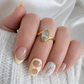 Woman wearing the Darya Ring, a gold marquise statement ring with a clear stone