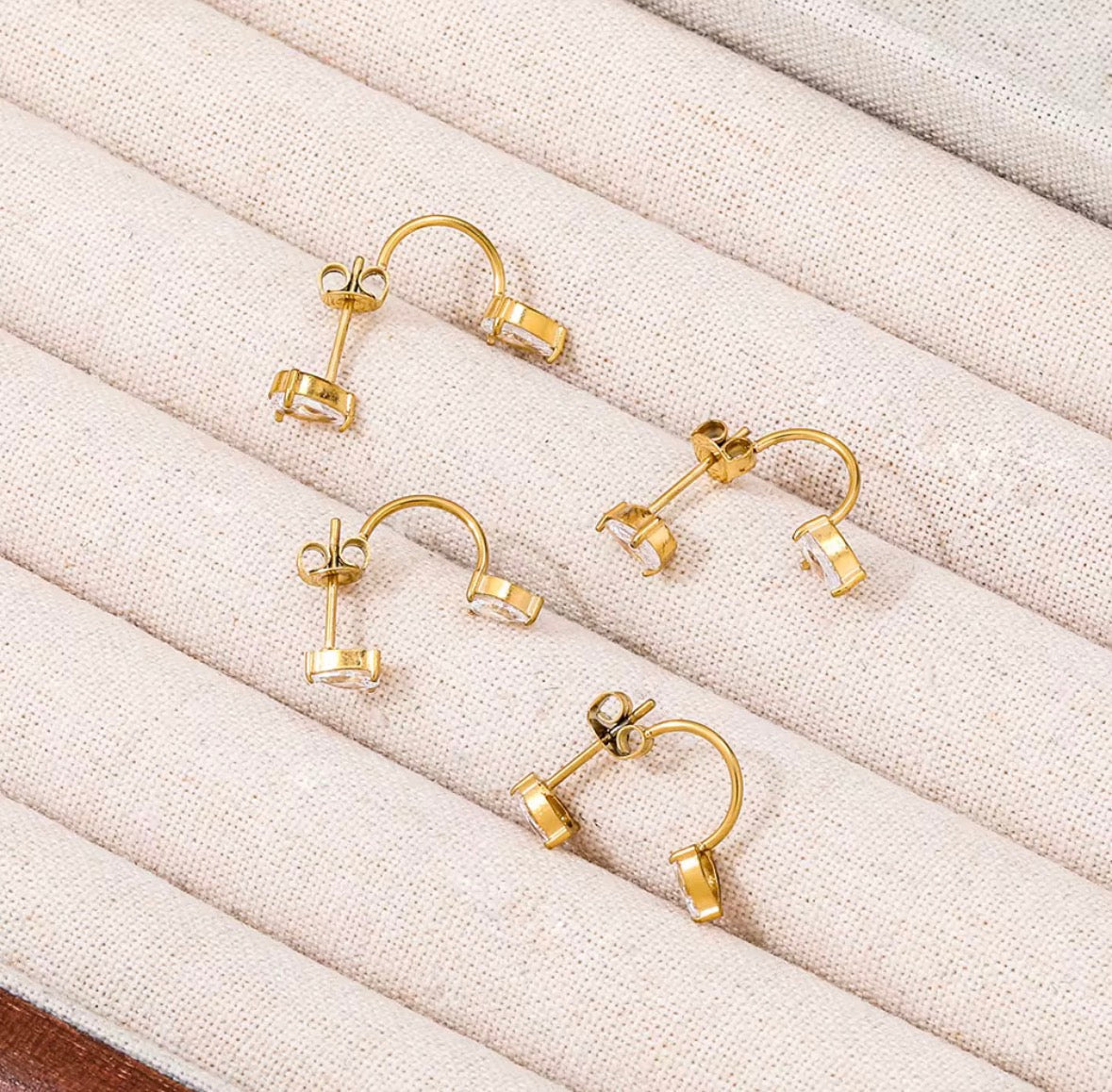 Back view of pear ear jacket earrings showing curved behind-ear design and double stud structure