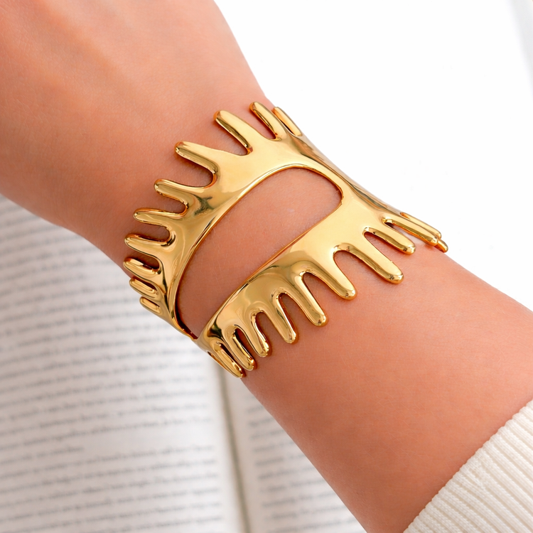 Close-up of gold drip cuff bracelet on wrist, waterproof non tarnish statement jewelry