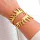 Close-up of gold drip cuff bracelet on wrist, waterproof non tarnish statement jewelry