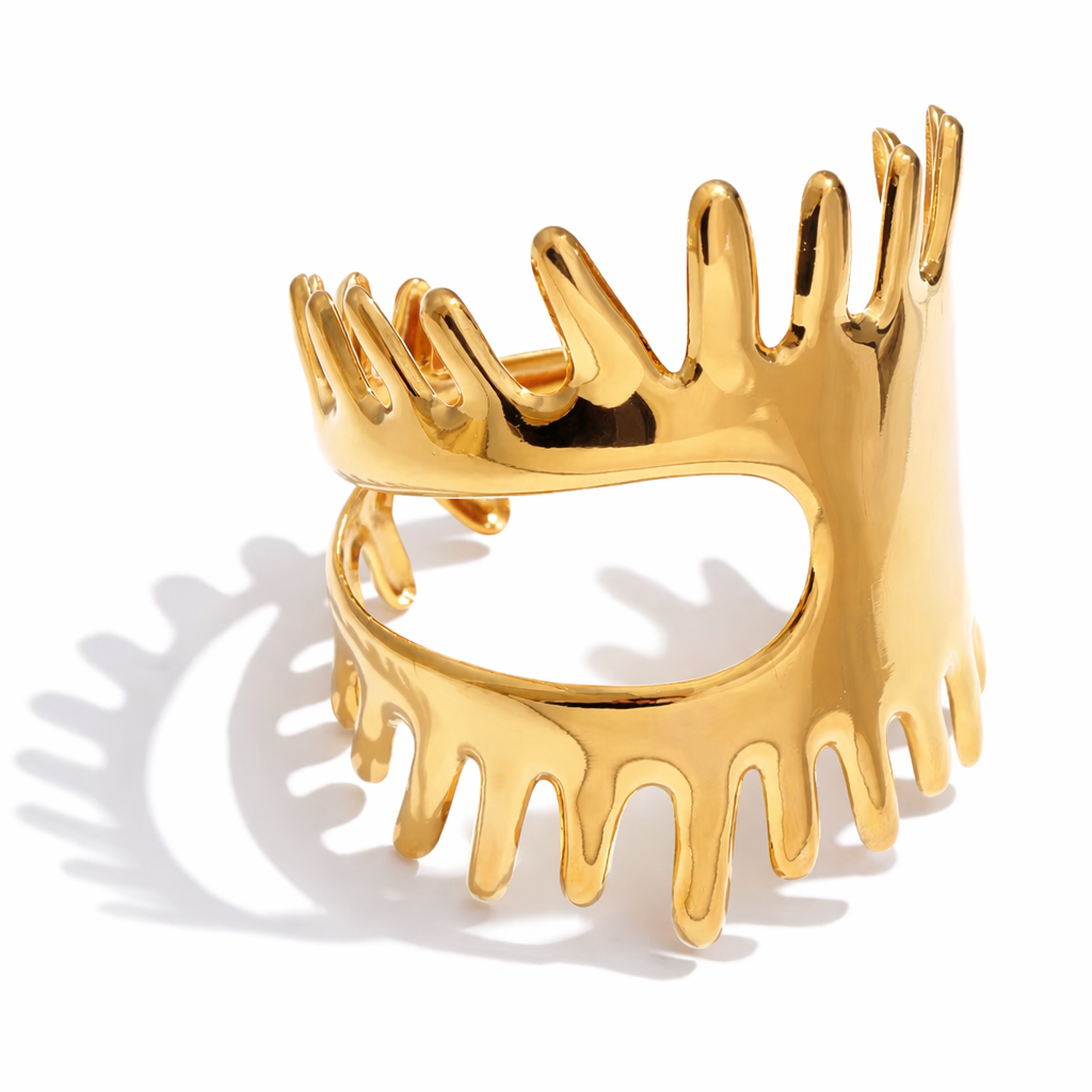 Gold statement cuff bracelet with molten drip design on white background, bold chunky gold jewelry
