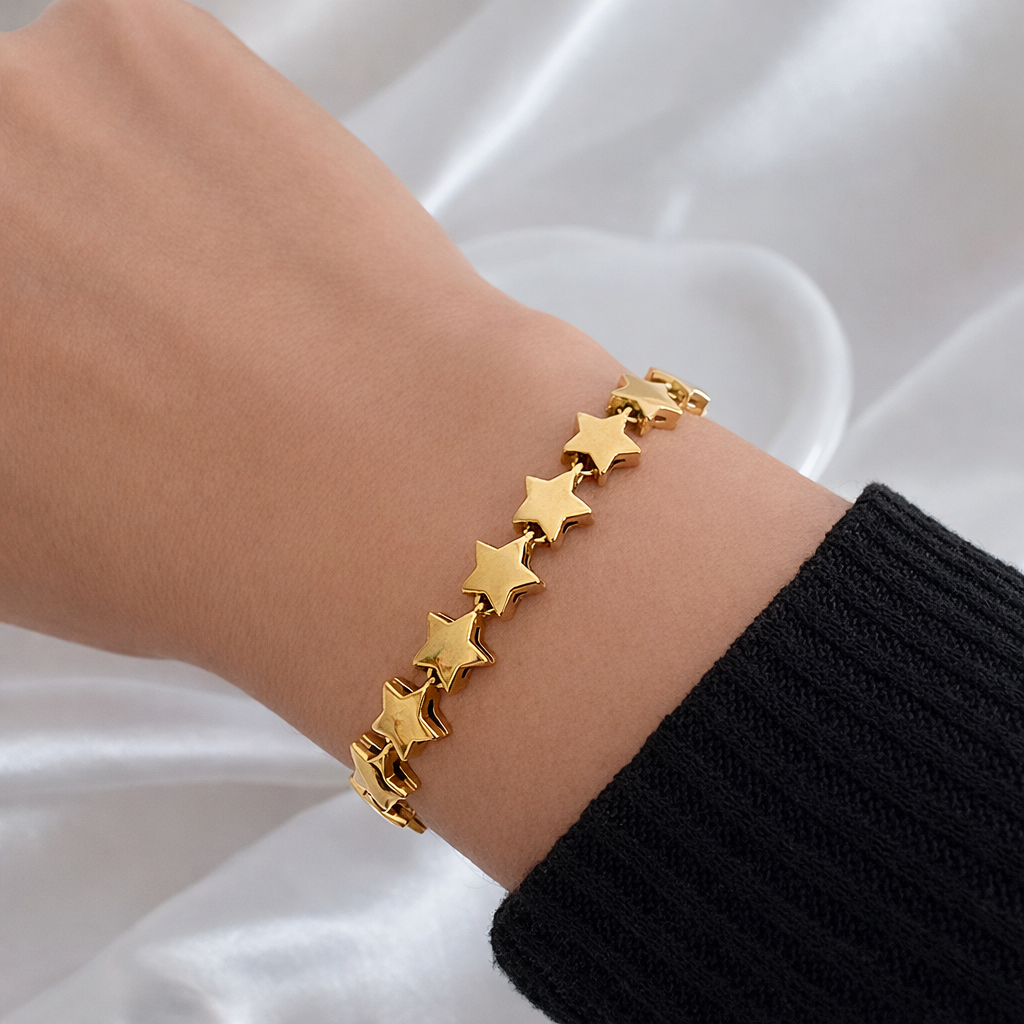Gold stars bracelet on wrist featuring linked star design, non tarnish stainless steel jewelry by XMTX Collections